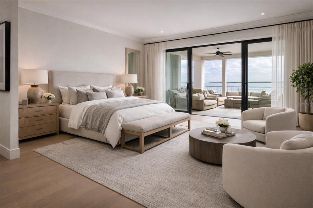 A bedroom with a king bed, seating area, and sliding doors opening to a balcony — 6043 BAYOU GRANDE BOULEVARD NE, ST PETERSBURG, FL