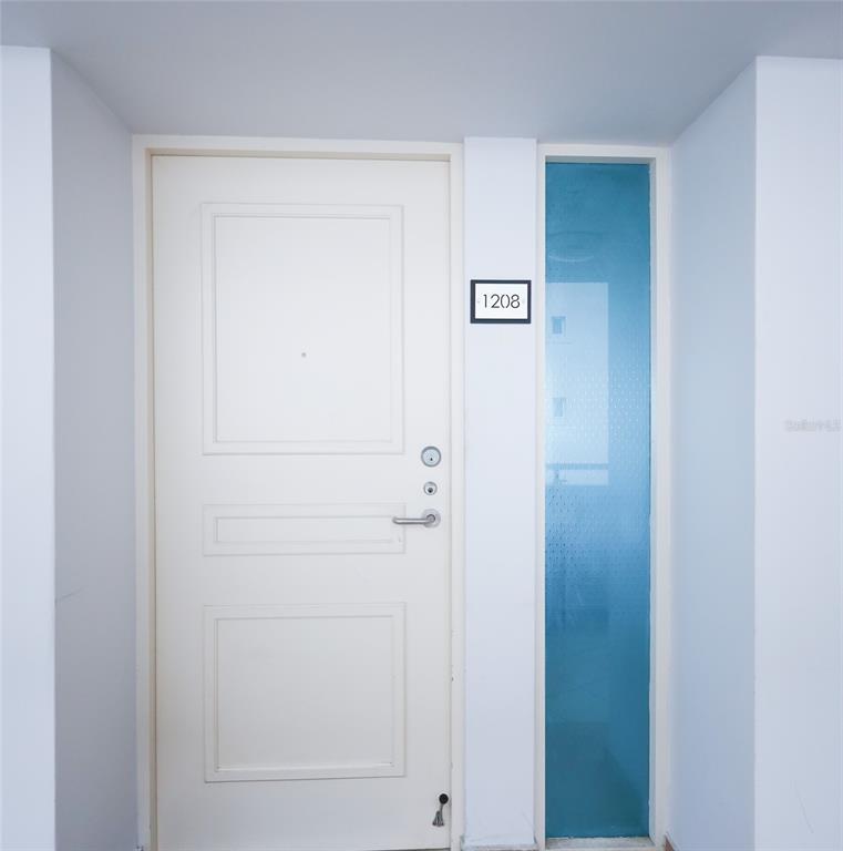 A white door with the number 1208 and an adjacent blue glass sidelight panel — 550 AVE FERNANDEZ JUNCOS UNIT 1208, SAN JUAN, PR