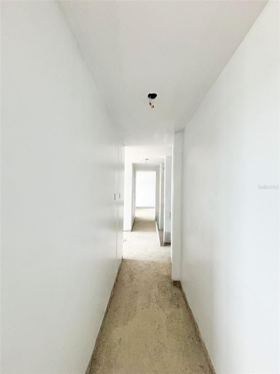 A narrow, unfinished hallway with white walls and exposed electrical wiring on the ceiling — 550 AVE FERNANDEZ JUNCOS UNIT 1208, SAN JUAN, PR
