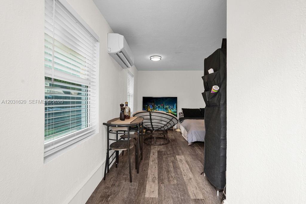 A small bedroom features a dining table, a papasan chair, and a bed — 3010 NW 95th Ter # A, Miami FL 33147, MIAMI, FL