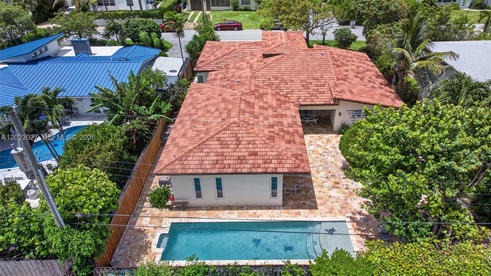 An aerial view shows a house with a red tile roof and a backyard pool — 3408 Dover Rd, Pompano Beach FL 33062, POMPANO BEACH, FL
