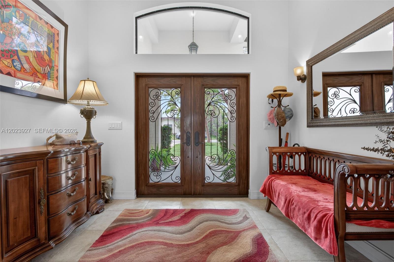 An entryway features double wooden doors with iron scrollwork, a red rug, and furniture — 3408 Dover Rd, Pompano Beach FL 33062, POMPANO BEACH, FL