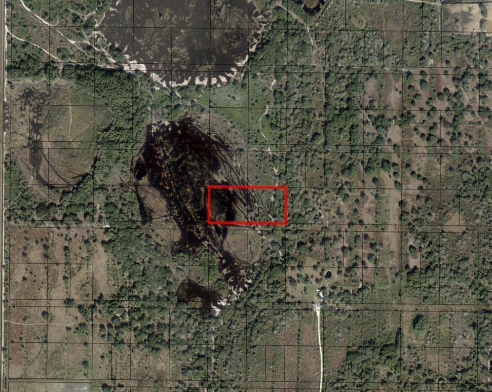 This aerial map shows a rectangular property boundary highlighted in red over a wooded landscape — 0 296th Street, Okeechobee FL 34972, OKEECHOBEE, FL