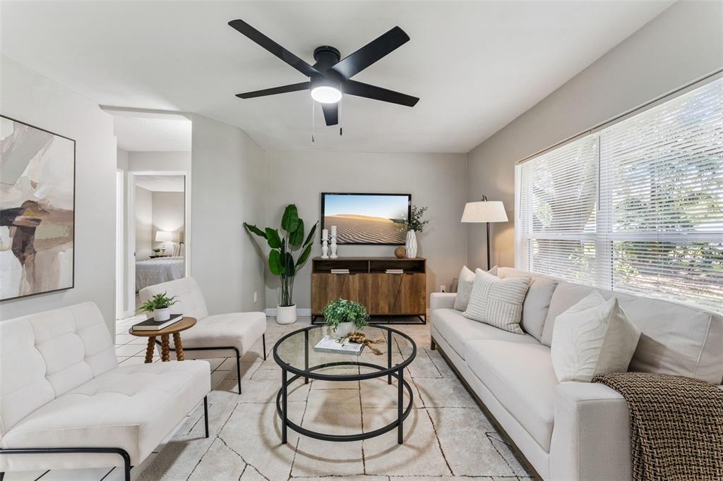 A living room features a white sofa, two chairs, a glass coffee table, and ceiling fan — 2581 JANS WAY, ALTAMONTE SPRINGS, FL