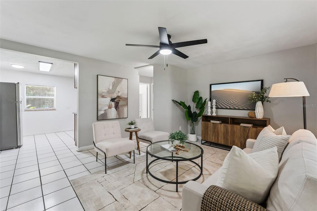 A living room features a ceiling fan, neutral furniture, a glass coffee table, and tile flooring — 2581 JANS WAY, ALTAMONTE SPRINGS, FL