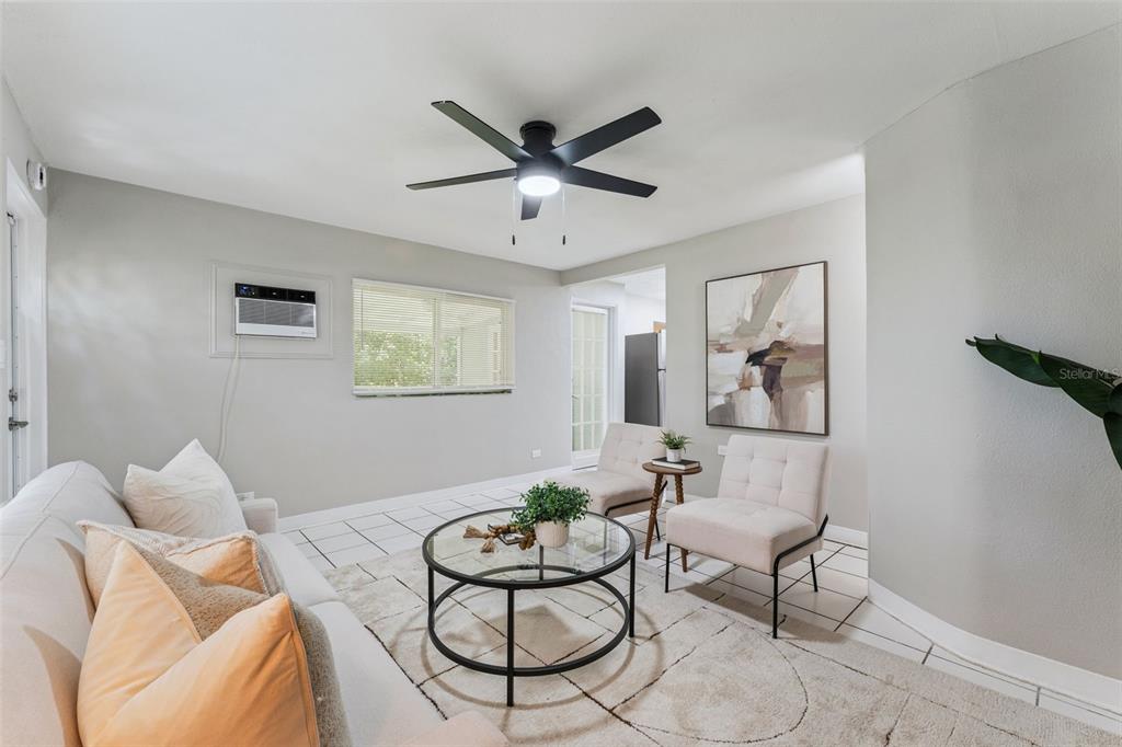 A living room features a white sofa, two accent chairs, a glass coffee table, and tile flooring — 2581 JANS WAY, ALTAMONTE SPRINGS, FL