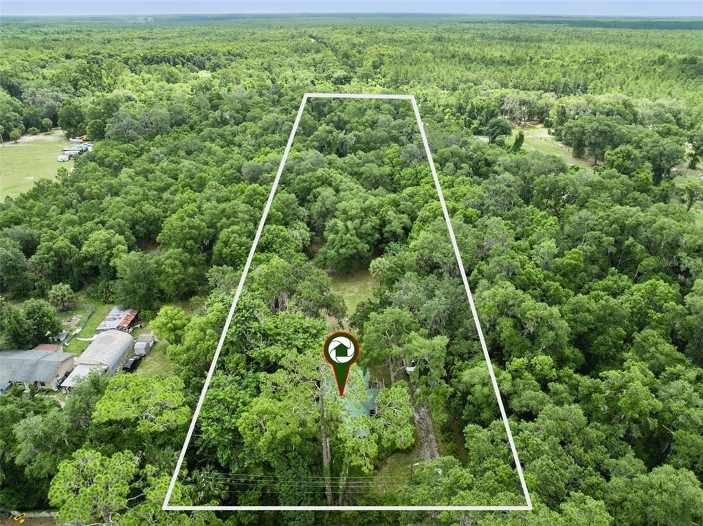 An aerial view shows a wooded lot with a house outlined in white — 1555 CHURCH STREET, PIERSON, FL