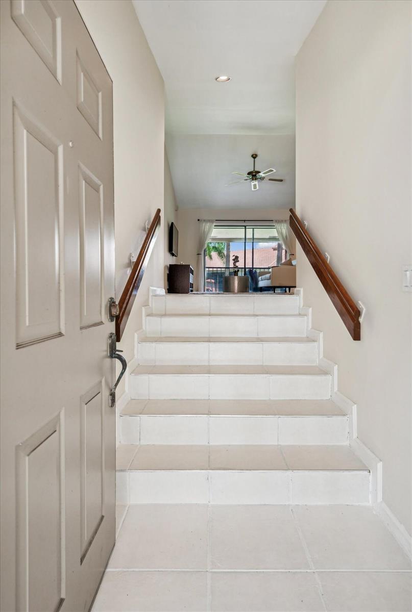 An entryway features a set of tiled stairs leading up to a living area — 5750 Coach House Circle # G, Boca Raton FL 33486, BOCA RATON, FL