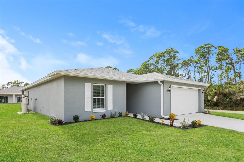 A single-story gray house with a white garage door and white window shutters — 3637 STARBOARD AVENUE, NORTH PORT, FL