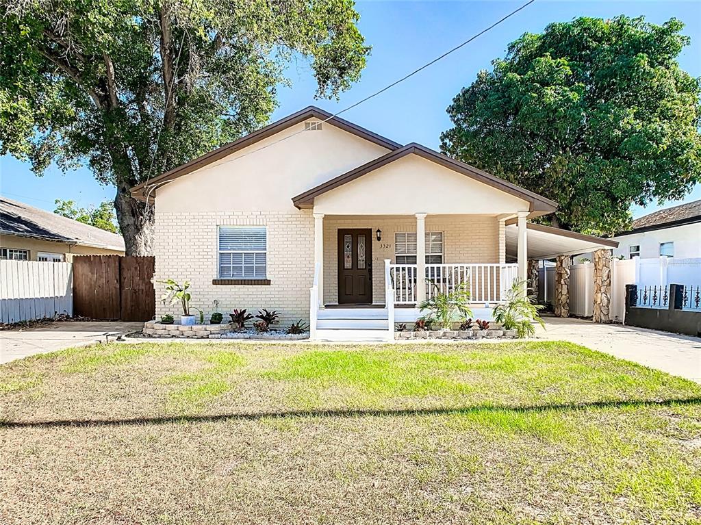 A single-story house with a brick facade, front porch, and a concrete driveway — 3321 W AILEEN STREET, TAMPA, FL