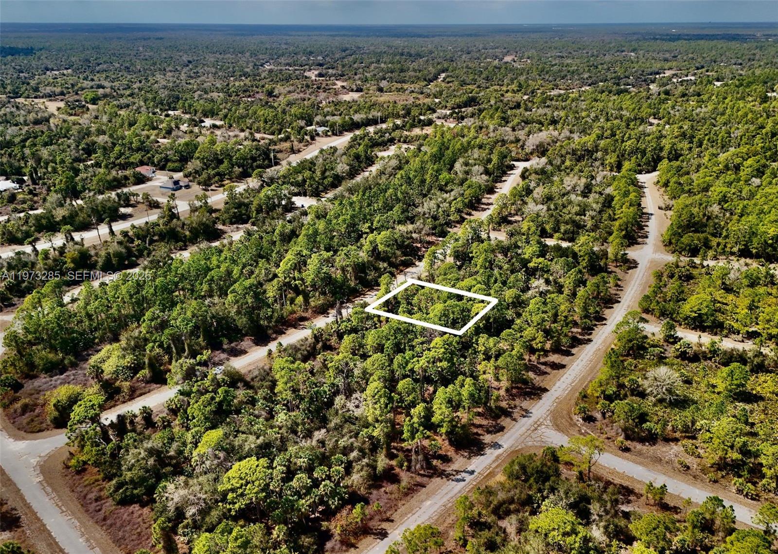 An aerial view shows a rectangular plot of land outlined in white amidst dense forest — 0 IRONSIDE ST, North Port FL 34288, NORTH PORT, FL