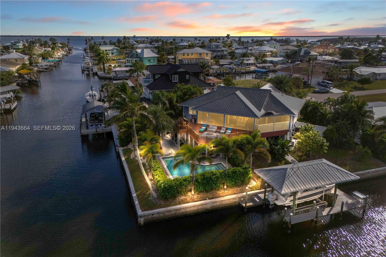 An aerial view shows a waterfront house with a pool, deck, and private boat dock — OTHER CITY - IN THE STATE OF FLORIDA, FL