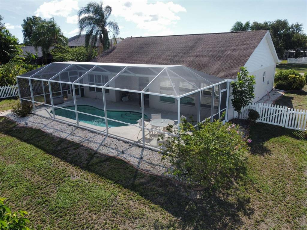 An aerial view of a house with a screened-in pool enclosure and a white fence — 4826 11TH AVENUE CIRCLE E, BRADENTON, FL