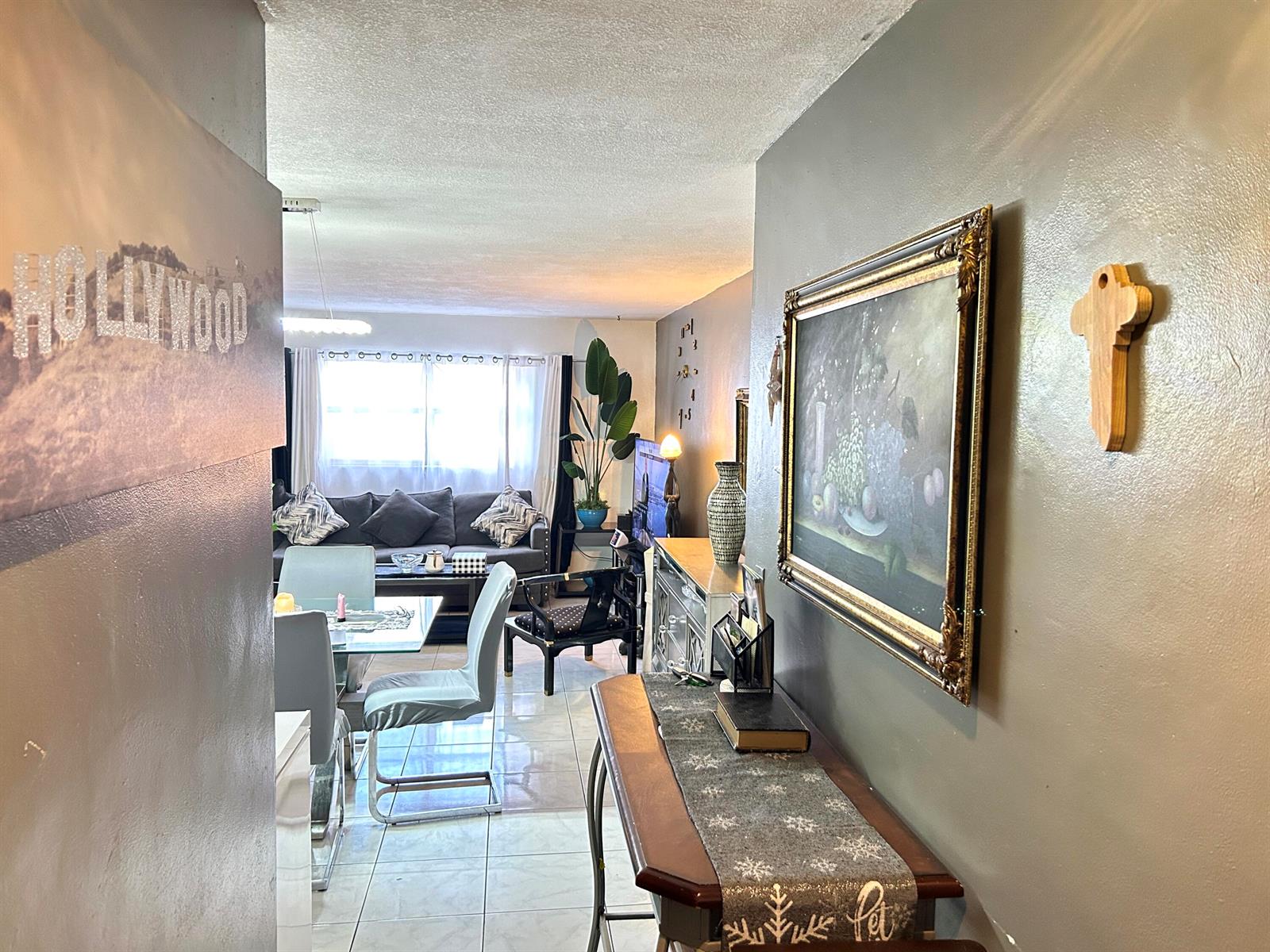 A view from a hallway into a living and dining area with tiled floors — 515 S Crescent Drive # 107, Hollywood FL 33021, HOLLYWOOD, FL