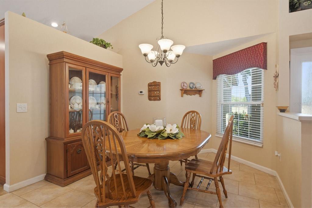 A dining room with a wooden table, chairs, a hutch, and a chandelier — 3228 BENTLEY DRIVE, PALM HARBOR, FL