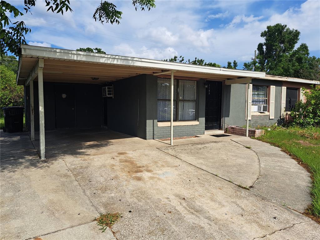 A single-story house with a carport, gray exterior, and a concrete driveway — 2183 PATTERSON AVENUE, ORLANDO, FL