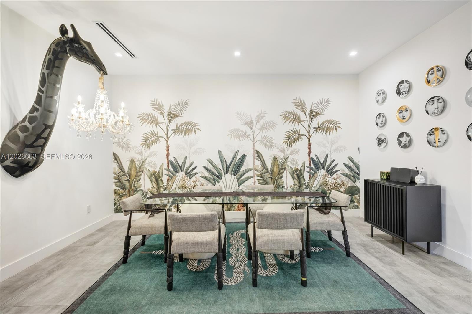A dining room features a giraffe wall sculpture, palm tree wallpaper, and a green rug — 3135 Ohio St # 3135, Miami FL 33133, MIAMI, FL