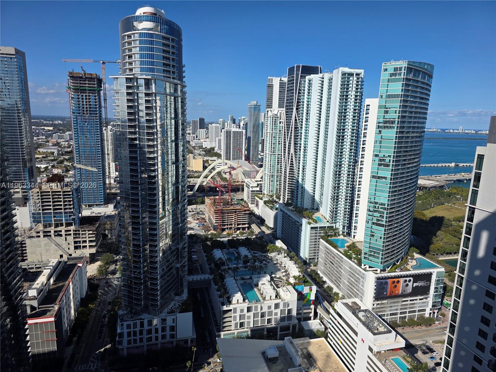 An elevated view of a dense urban skyline featuring numerous modern glass skyscrapers and construction sites — 159 NE 6th street # 3311, Miami FL 33132, MIAMI, FL