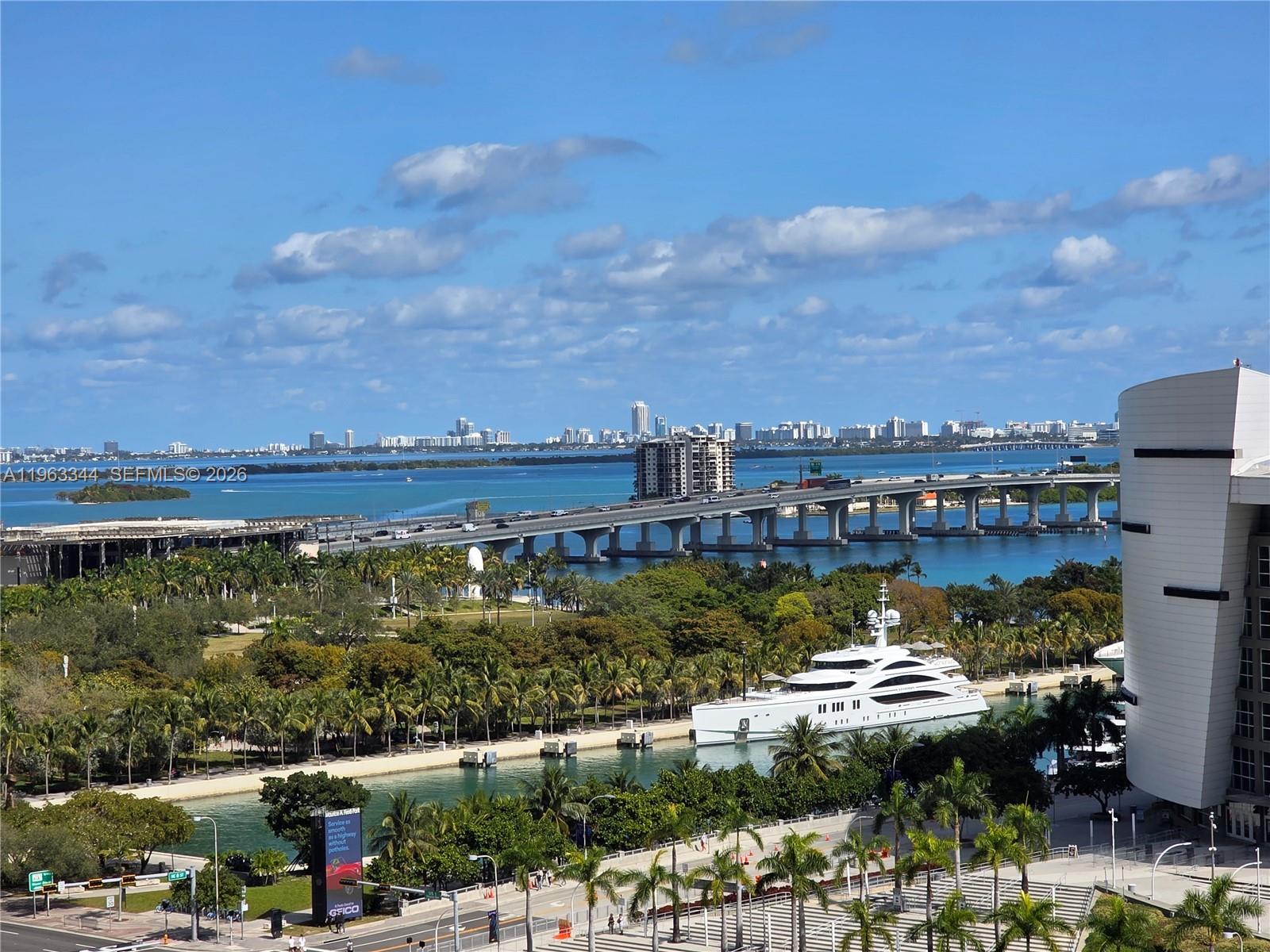 An elevated view shows a bridge over water, a large yacht, and a city skyline — 159 NE 6th street # 3311, Miami FL 33132, MIAMI, FL