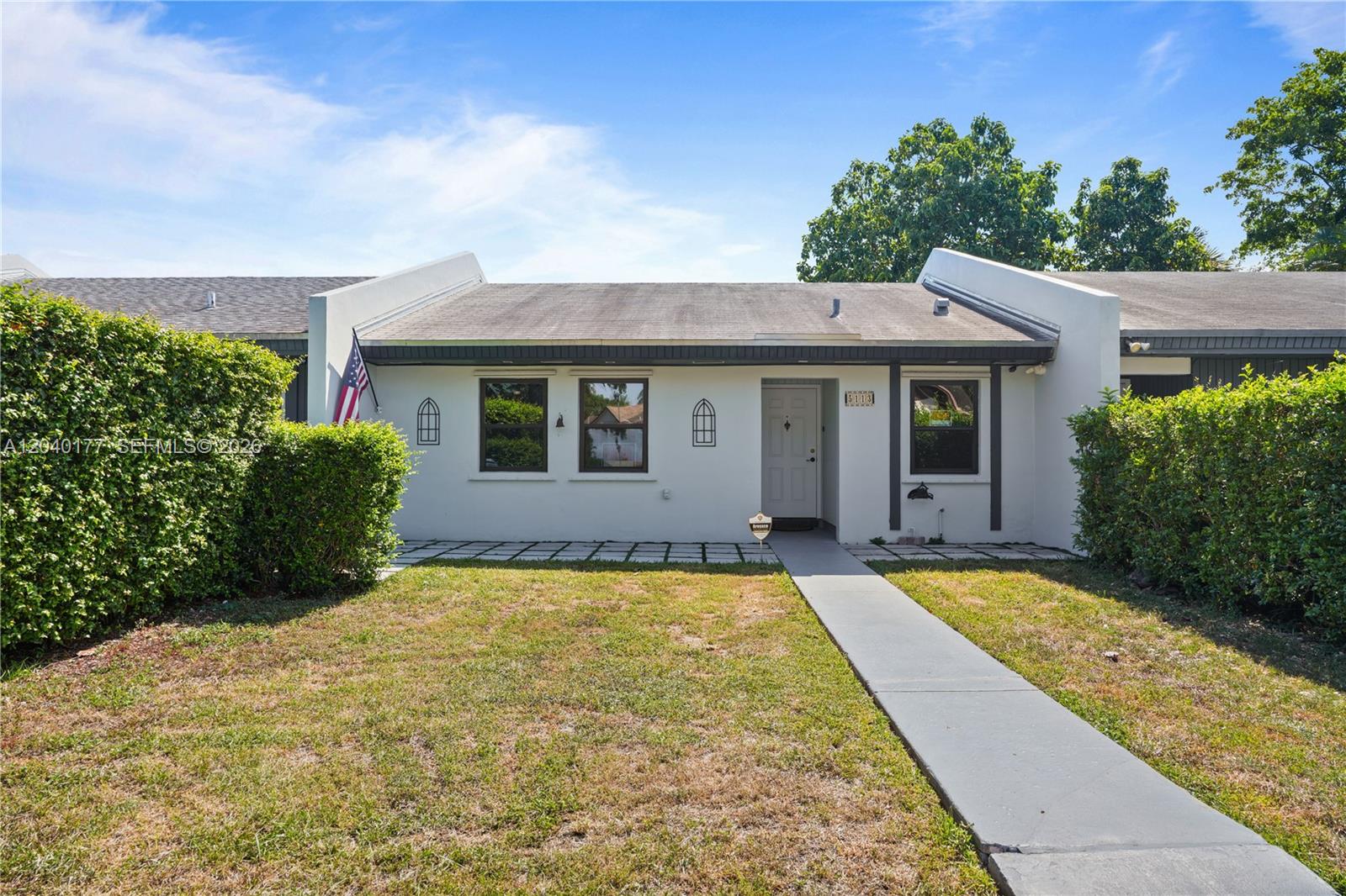 A single-story white house with a gray roof, front walkway, and green hedges — 5113 SW 138th Ave Cir, Miami FL 33175, MIAMI, FL
