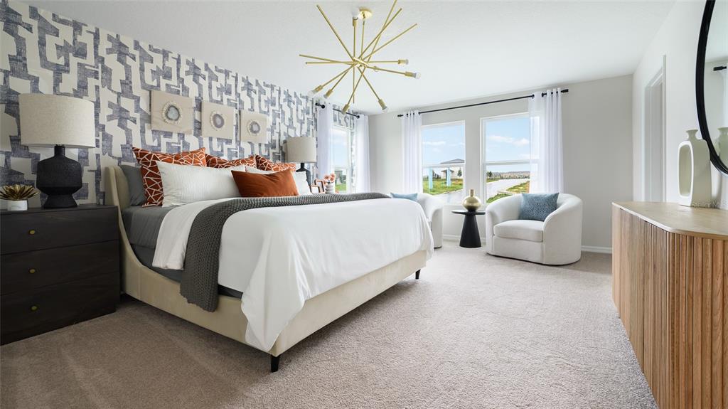 A bedroom features a patterned accent wall, a gold sputnik chandelier, and a king-sized bed — 36656 THORNHEDGE DRIVE, ZEPHYRHILLS, FL
