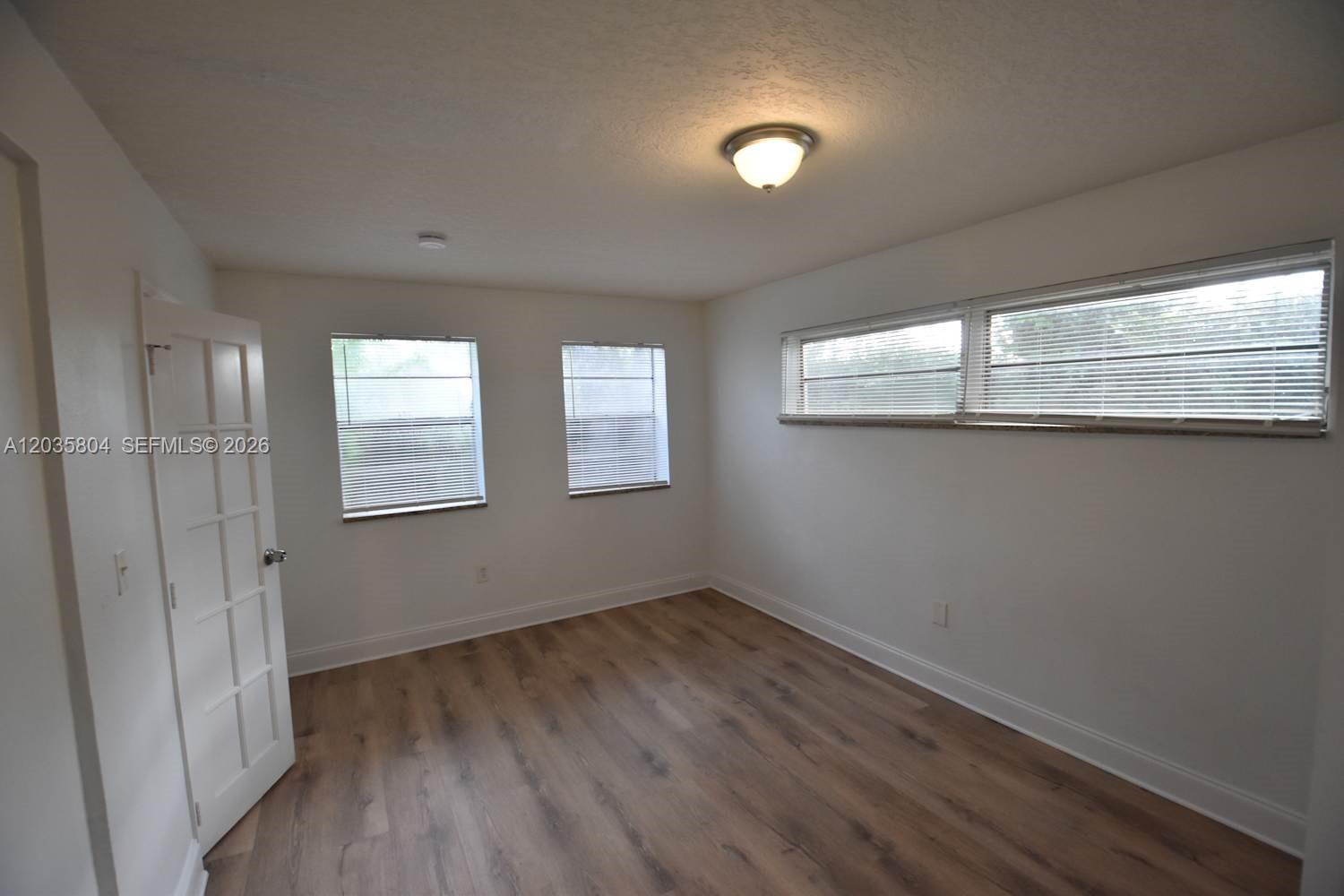 An empty dining area features beige walls, tiled flooring, and an adjacent kitchen counter — PEMBROKE PINES, FL