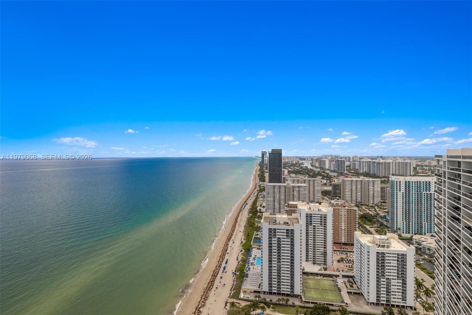 An aerial view shows a sandy beach along the ocean next to high-rise buildings — 1830 S Ocean Dr # 4502, Hallandale Beach FL 33009, HALLANDALE BEACH, FL