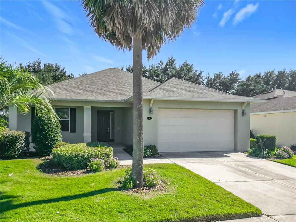 An aerial view shows three suburban houses with gray roofs, driveways, and green lawns — 3507 ARLINGTON RIDGE BOULEVARD, LEESBURG, FL