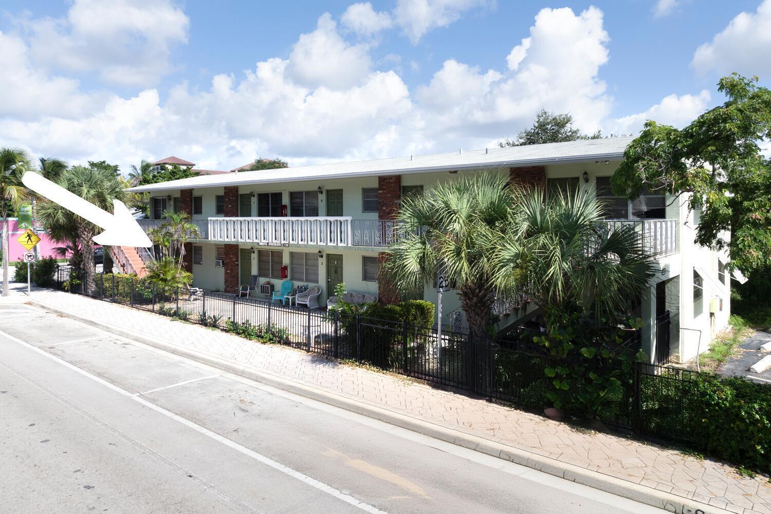 A two-story apartment building with a white balcony and a black metal fence — 220 Lucerne Avenue # 1, FL 33460, FL