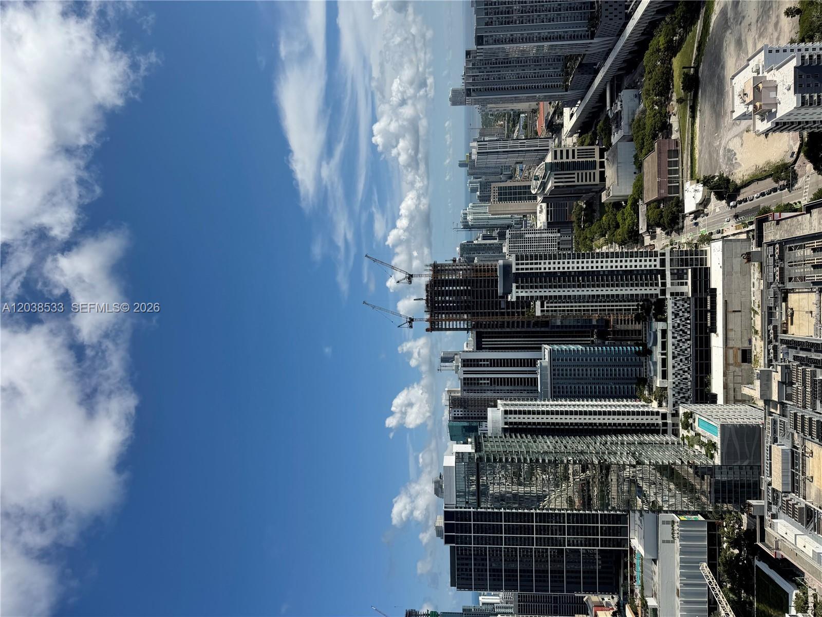 An aerial view of a dense urban skyline featuring high-rise buildings and construction cranes — 20 NE 11th st # 5305, Miami FL 33132, MIAMI, FL