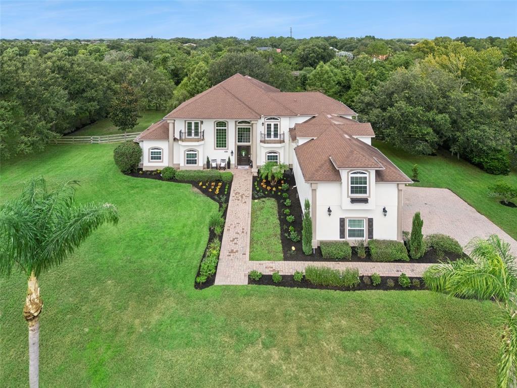 An aerial view of a large two-story house with a brown roof and white exterior — 4282 MCKINNON ROAD, WINDERMERE, FL