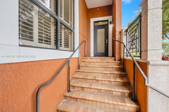 A set of brick stairs leads to a dark front door with a window above — 8395 SW 73rd Ave # 104, Miami FL 33143, MIAMI, FL