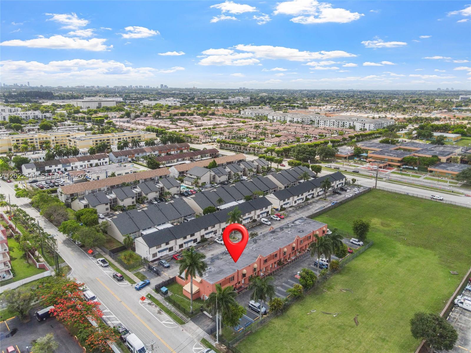 An aerial view shows a multi-story residential complex with a red pin marking a building — 8454 NW 8th St # 2, Miami FL 33126, MIAMI, FL