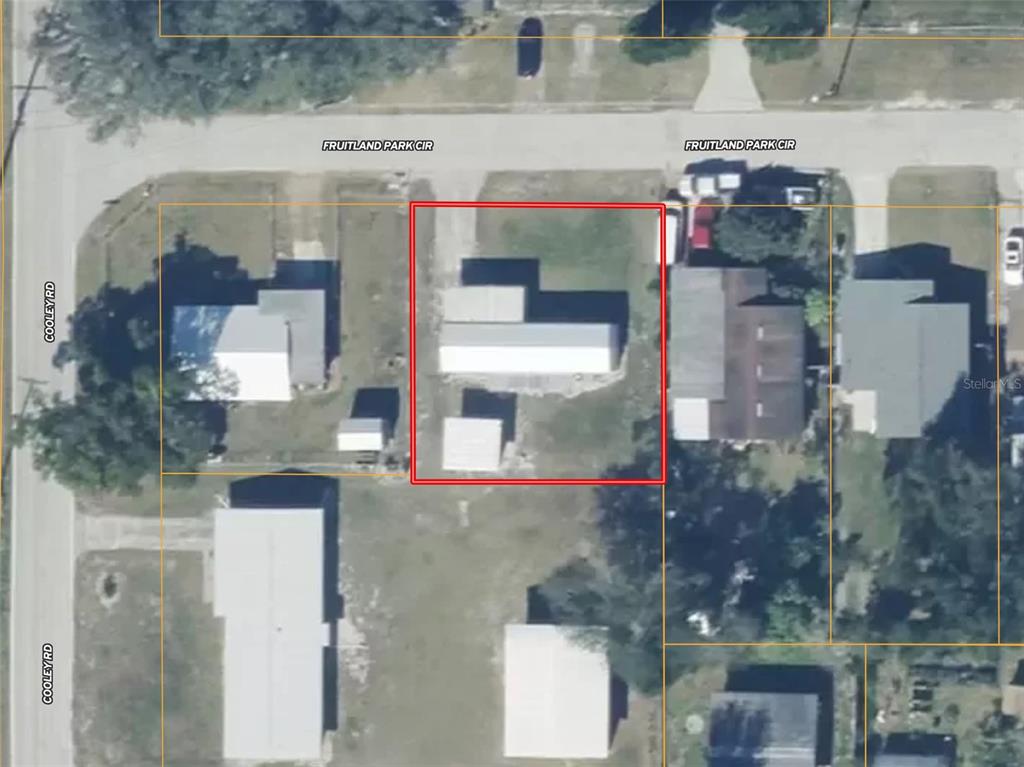 This aerial map shows a residential property lot highlighted in red on a street corner — 1821 FRUITLAND PARK CIRCLE, EAGLE LAKE, FL