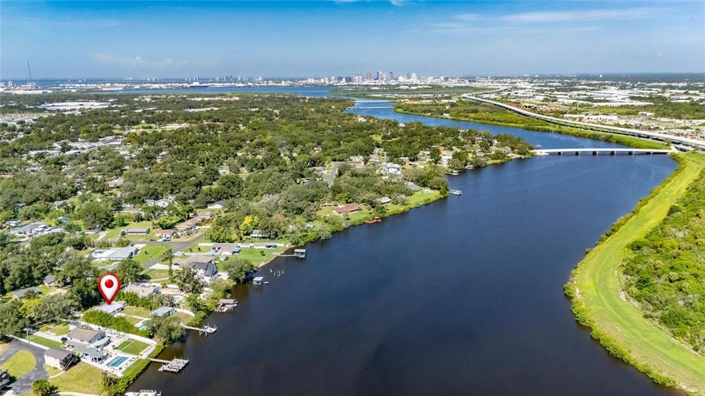 An aerial view shows a waterfront house with a pool along a river — 6712 MYRNA DRIVE, TAMPA, FL