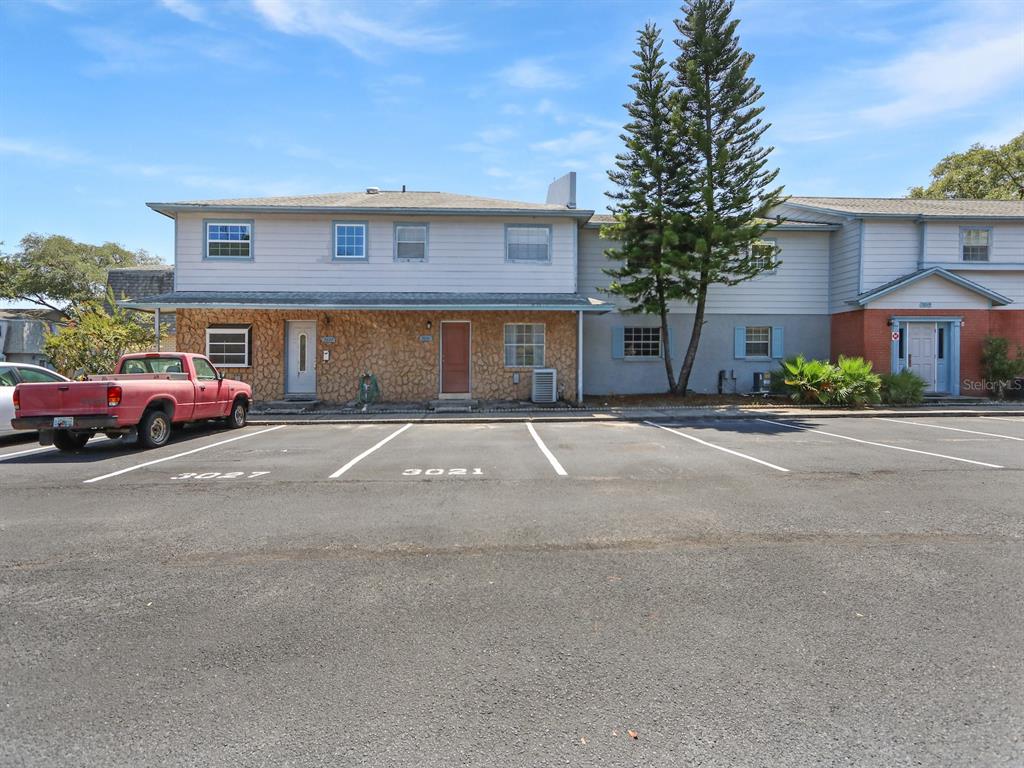A two-story residential building with stone siding and a parking lot in the foreground — 3021 AARON BURR AVENUE UNIT 3, WINTER PARK, FL