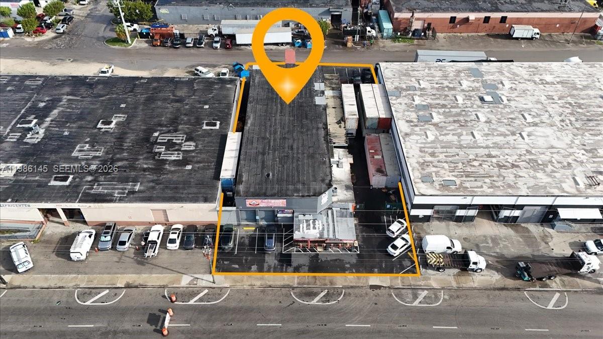 An aerial view shows a commercial building with a flat roof and parking lot — 3595 NW 54th St, Hialeah FL 33142, HIALEAH, FL