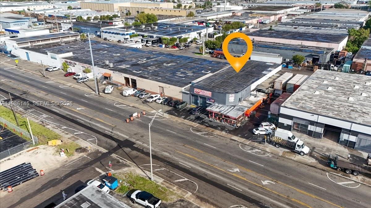 An aerial view shows a commercial warehouse building with a parking lot and street frontage — 3595 NW 54th St, Hialeah FL 33142, HIALEAH, FL