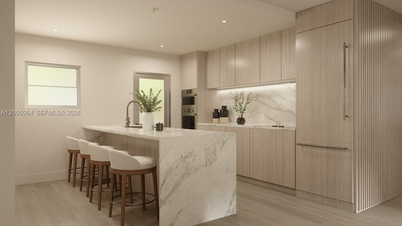 This is a rendering of a modern kitchen featuring a marble island and light wood cabinetry — 260 Collins Ave # 201, Miami Beach FL 33139, MIAMI BEACH, FL
