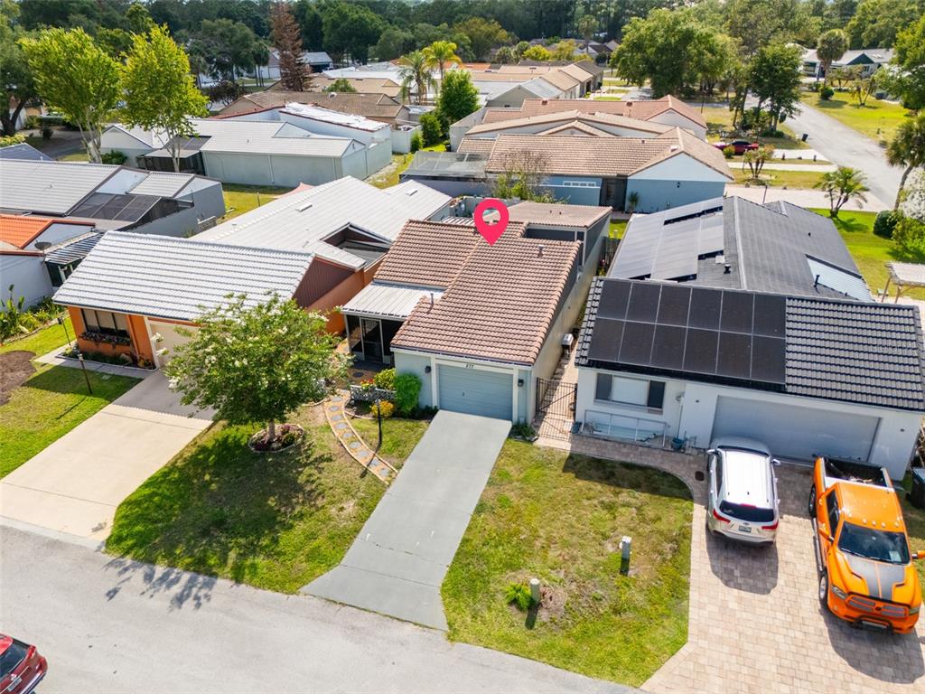 An aerial view shows a residential street with a single-story house featuring a tiled roof — 277 MARIPOSA, WINTER HAVEN, FL