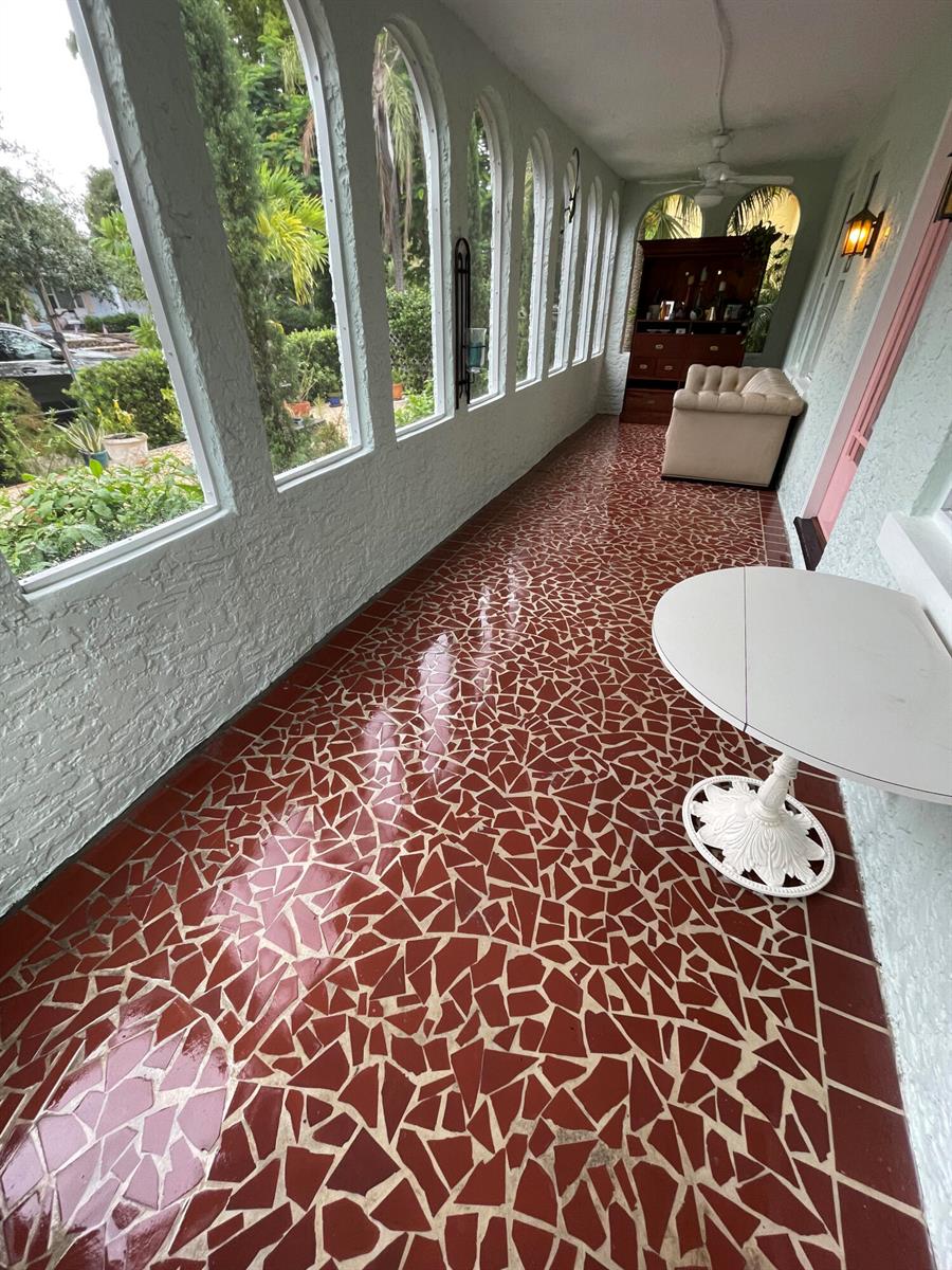 A sunroom features arched windows, a red mosaic tile floor, and a small white table — 312 Fordham Drive, Lake Worth FL 33460, LAKE WORTH, FL