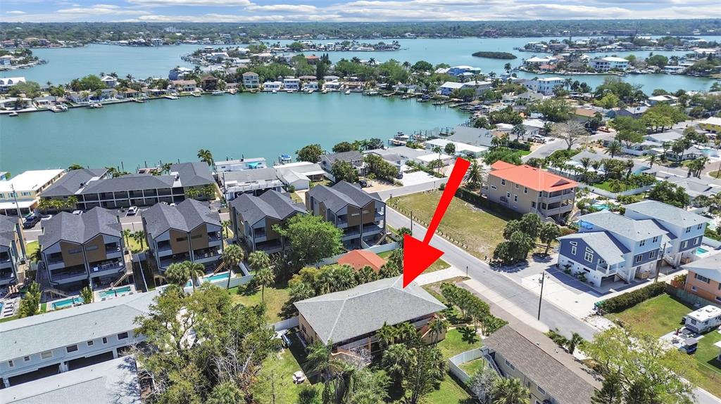 An aerial view shows a residential neighborhood with a house highlighted by a red arrow — 206 22ND AVENUE, INDIAN ROCKS BEACH, FL