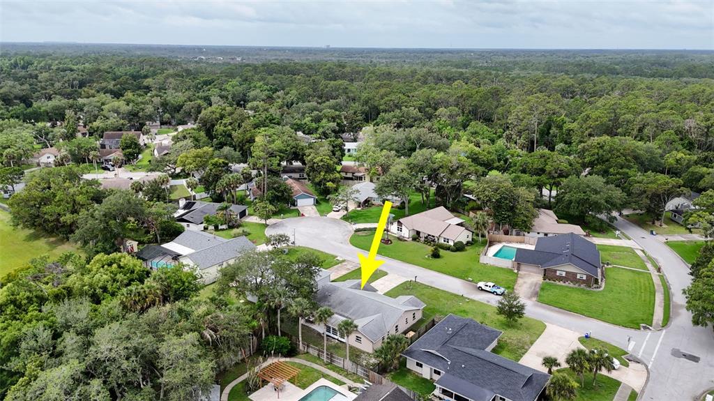 An aerial view shows a residential neighborhood with a single-story house highlighted by an arrow — 3 OVERBROOK COURT, ORMOND BEACH, FL