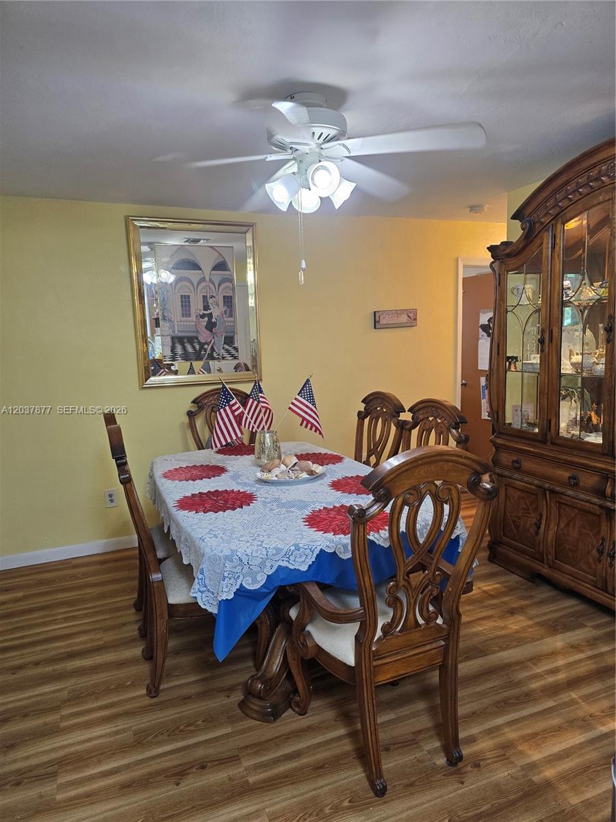 A dining room features a wooden table with chairs, a hutch, and a ceiling fan — 19500 SW 87th Ave, Cutler Bay FL 33157, CUTLER BAY, FL