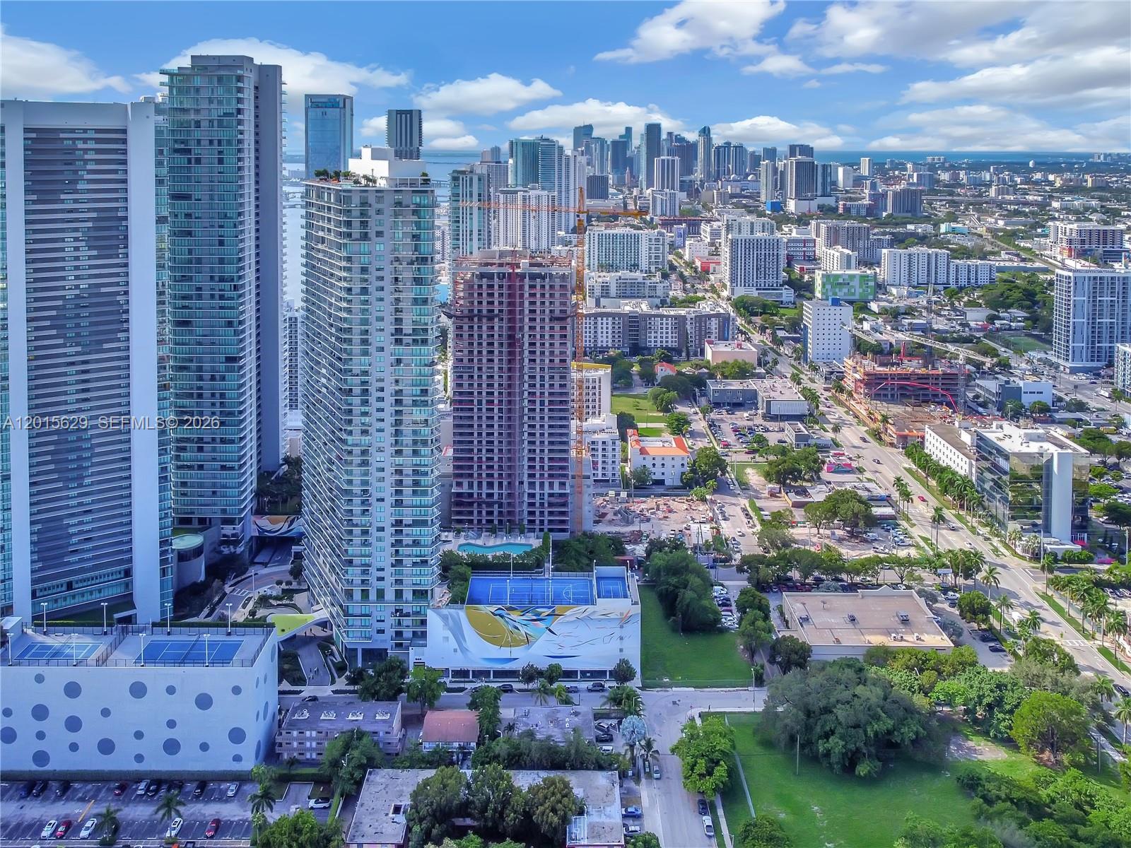 An aerial view shows several high-rise residential towers and construction sites in a city — 501 NE 31st St # 608, Miami FL 33137, MIAMI, FL