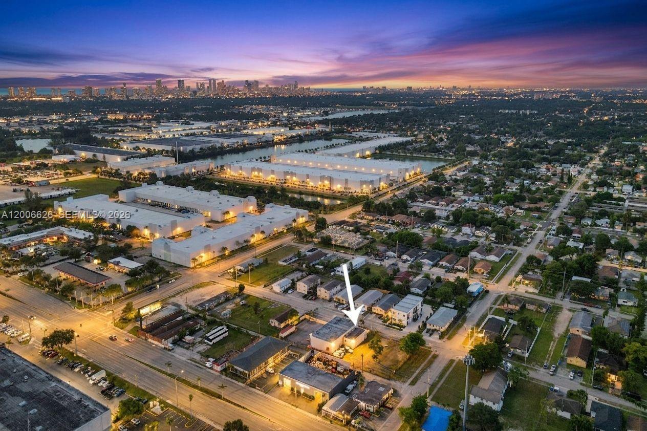 An aerial view shows a commercial building highlighted by an arrow amidst a suburban landscape — 4167 SW 18th St, West Park FL 33023, WEST PARK, FL