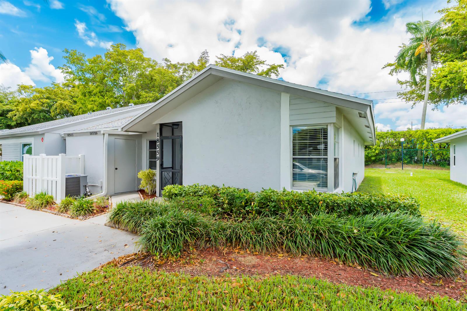 A single-story house with a light gray exterior, a front entrance, and a landscaped yard — 18559 Egret Way, Boca Raton FL 33496, BOCA RATON, FL