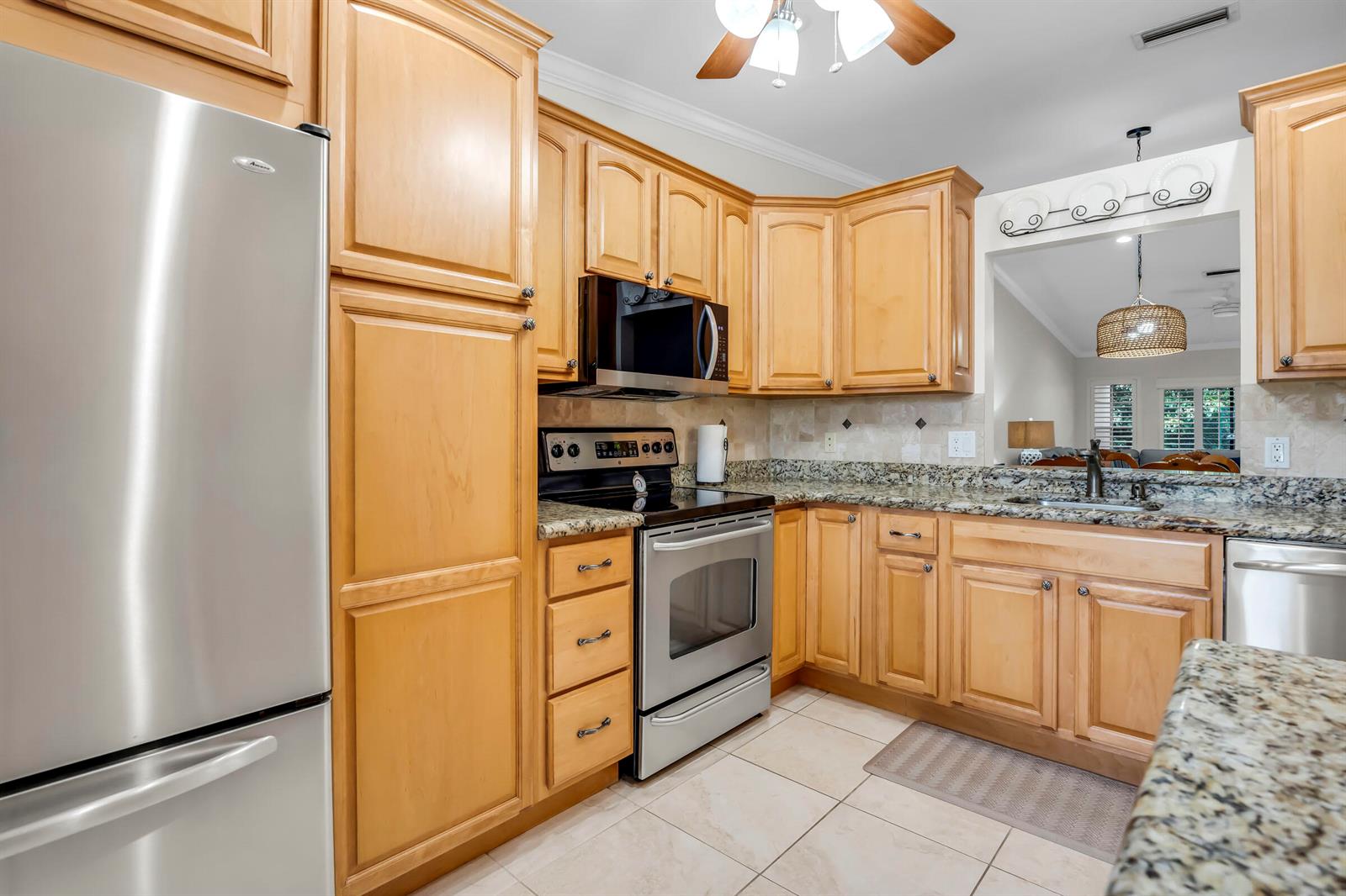 A kitchen with light wood cabinets, stainless steel appliances, and granite countertops — 18559 Egret Way, Boca Raton FL 33496, BOCA RATON, FL