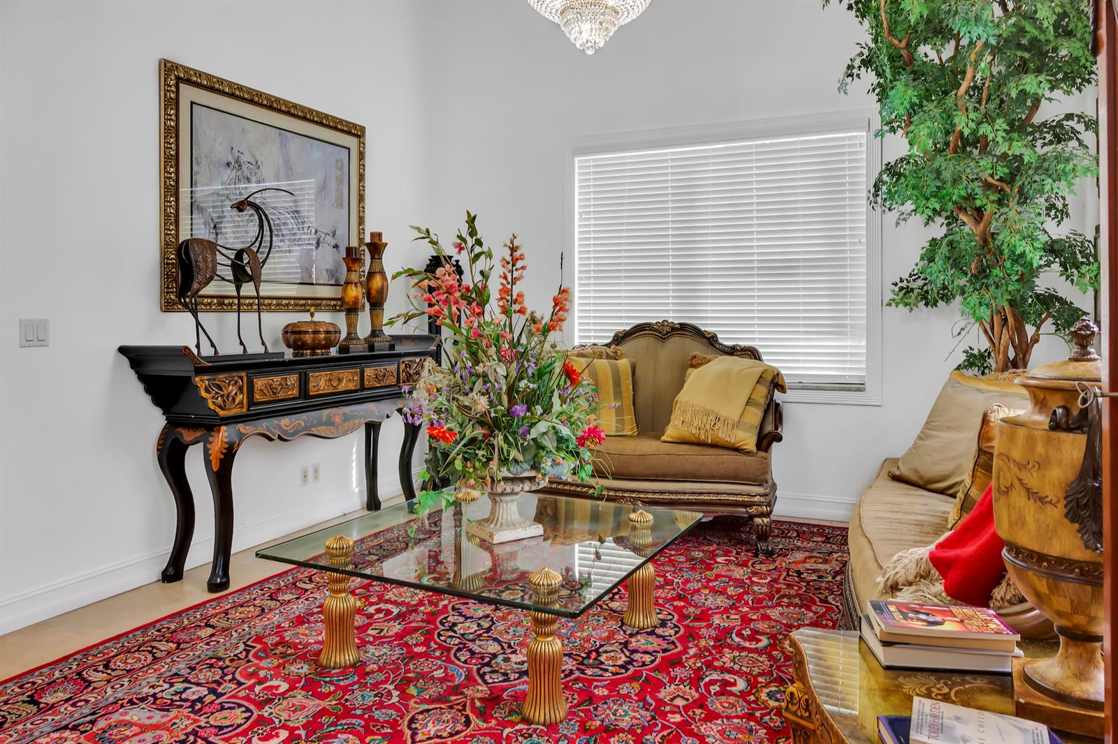 A formal living room features a glass coffee table, ornate console table, and red rug — 12121 70th Place N, FL 33412, FL