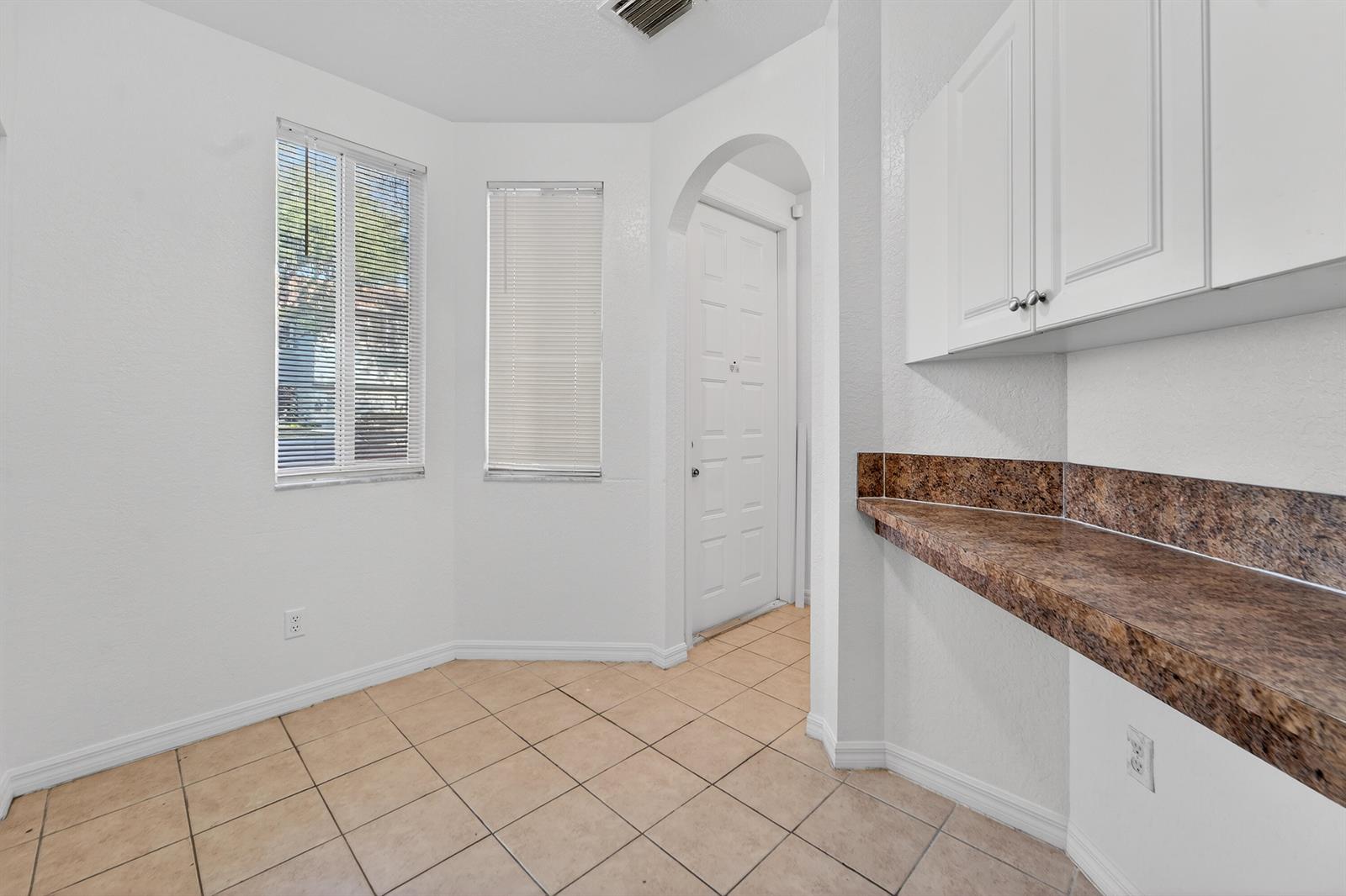 A room with tile flooring, white walls, a built-in counter, and a white door — 3635 Sonoma Drive, Riviera Beach FL 33404, RIVIERA BEACH, FL